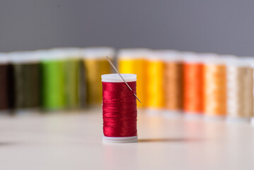 red thread with a needle, dressmaker, atelier, sewing, sewing clothes, embroidering a fabric,...