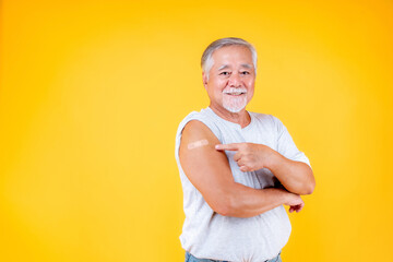 old man potint arm with plaster fully vaccinated or booster vaccinated able to travel to various countries , elderly man fully vaccinated or booster vaccinated.