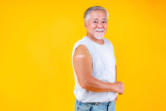 old man showing arm with plaster fully vaccinated or booster vaccinated able to travel to various countries , elderly man fully vaccinated or booster vaccinated.