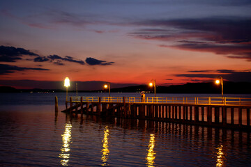 Fototapeta na wymiar Sunset on lake Trasimeno from Passignano, Italy