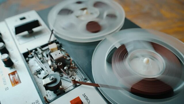 Fast-forward tape in an old reel-to-reel tape recorder.
