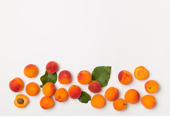 Flat lay with ripe apricots on white background, top view