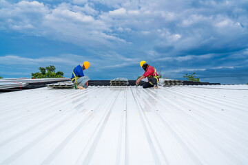Teamwork of Roofer working at new roof under construction. Safety body construction, Fall arrestor...