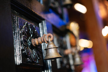 Indian temple bell at the entrance wooden door