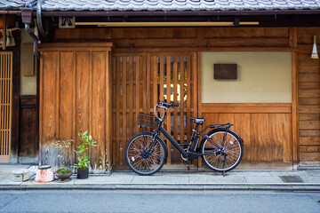 Black bicycle park outside a random Japan wooden house