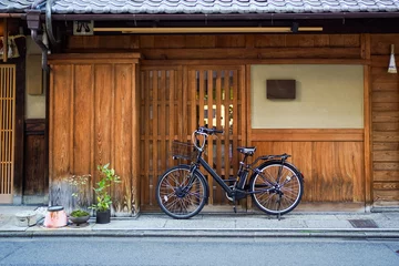 Foto op Canvas Black bicycle park outside a random Japan wooden house © JCM