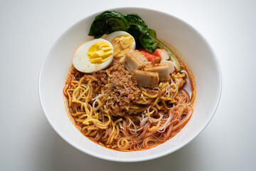 Spicy prawn noodle, “Hokkien Mee” (Hokkien) or “Har Mee” (Cantonese) in isolated white background. Spicy prawn noodle is a very popular and famous noodle in Malaysia and Singapore.