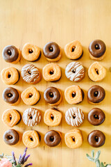 Set of delicious doughnuts on table