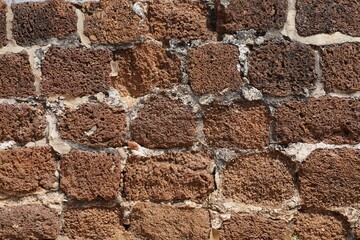 Stone wall texture background. Stone arrangement in pattern. Abandoned stone wall construction in the historical heritage site at shore temple complex at Mahabalipuram, Tamilnadu, India.