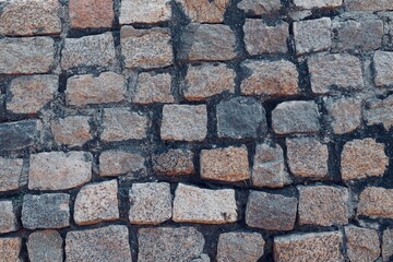 Stone wall texture background. Stone arrangement in pattern. Abandoned stone wall construction in the historical heritage site at shore temple complex at Mahabalipuram, Tamilnadu, India.