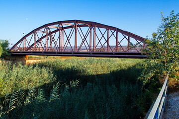 Nice landscape with an old metal bridge that crosses over the Segura River that carries water to irrigate the garden of Murcia