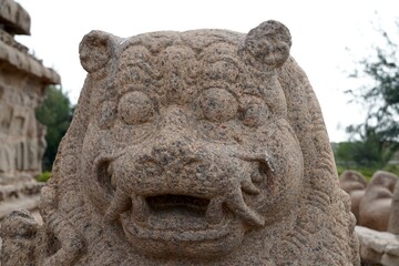 Monolithic stone carved lion sculpture in the complex of Shore temple at Mahabalipuram, Tamilnadu, India. Historical animal sculpture carvings in the heritage sites at India.
