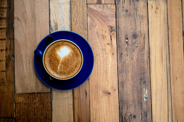 A milk coffee on a wood table