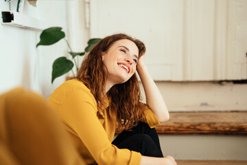 Naklejka premium Young woman looking up happily