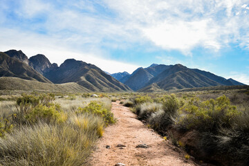 dirt road in mountains landscape in sunny day