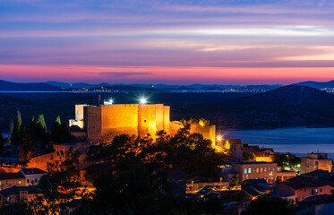 Evening Sibenik city in Croatia, night city lights reflection, cityscape