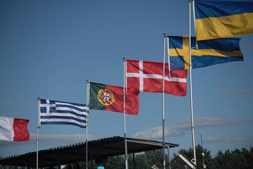COURSEULLES-SUR-MER, FRANCE. JULY 25, 2018: National flags of the allied countries during II World War, in Juno Beach, one place where it was Normandy's landing in 1944. Memorial canadian soldiers.