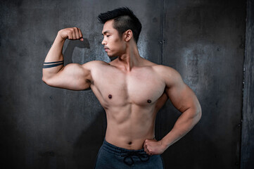 Fototapeta premium Portrait of asian man big muscle at the gym,Thailand people,Workout for good healthy,Body weight training,Fitness at the gym concept