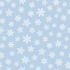 White snowflakes on pastel blue background seamless pattern.  Best for textile, wallpapers, wrapping paper and seasonal decoration.