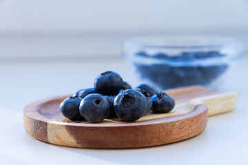 Blueberries on a wooden table. Fresh berries. Wild blueberries on a wooden stand