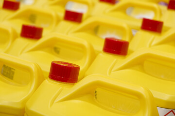 Yellow Plastic bottles cans Yellow household chemicals Liquid Refill in the hardware warehouse...