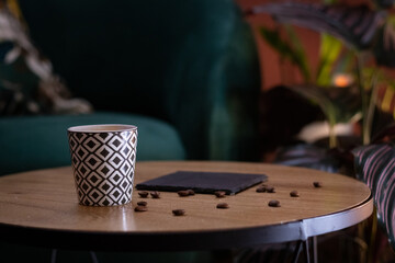 wood table with coffee cup and coffee beans