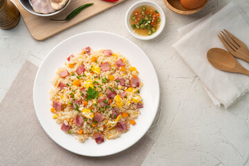 Thai Fried rice with egg and sliced ham carrot in white plate.Easy cooking food.Top view