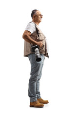 Fototapeta premium Full length profile shot of a mature male photographer carrying a camera