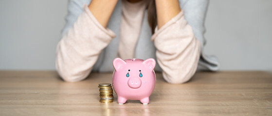 Sad girl with a crying piggy bank.