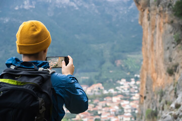 Fototapeta premium Man is making photos on mobile phone during travel.