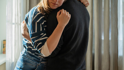 A couple in romantic relationship, girl warm hugs a man.
