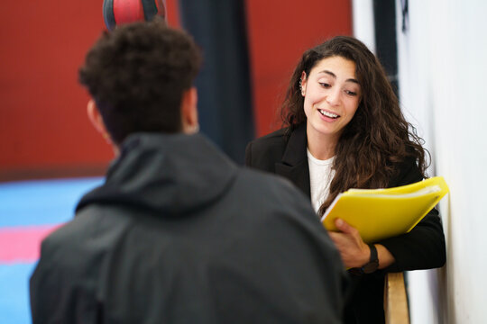 Friendly Sports Psychologist Discussing Assignment With Sportsman