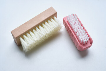 Shoe brushes and cleaning cloth close-up on a light background