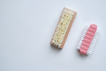 Shoe brushes and cleaning cloth close-up on a light background