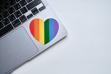 Rainbow heart is pasted on the laptop. LGBT flag. LGBTQIA Pride Month in June. Lesbian gay bisexual...