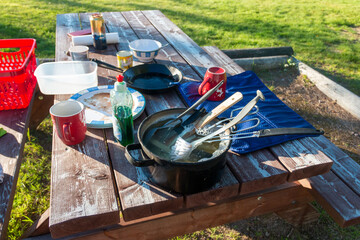 outside washing dishes at camping