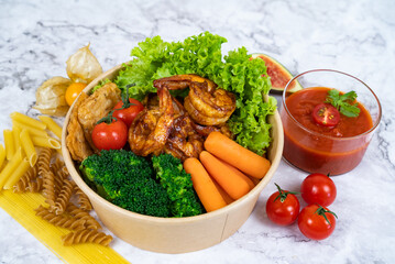GRILLED TERIYAKI PRAWN with carrot, tomato, leaves, and ketchup served in a bowl isolated on grey background side view healthy korean food