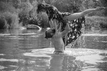 caucasian couple in love having a bath in a lake