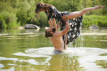 caucasian couple in love having a bath in a lake
