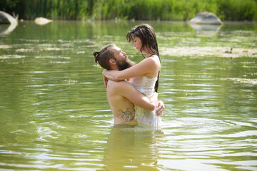 Fototapeta premium caucasian couple in love having a bath in a lake