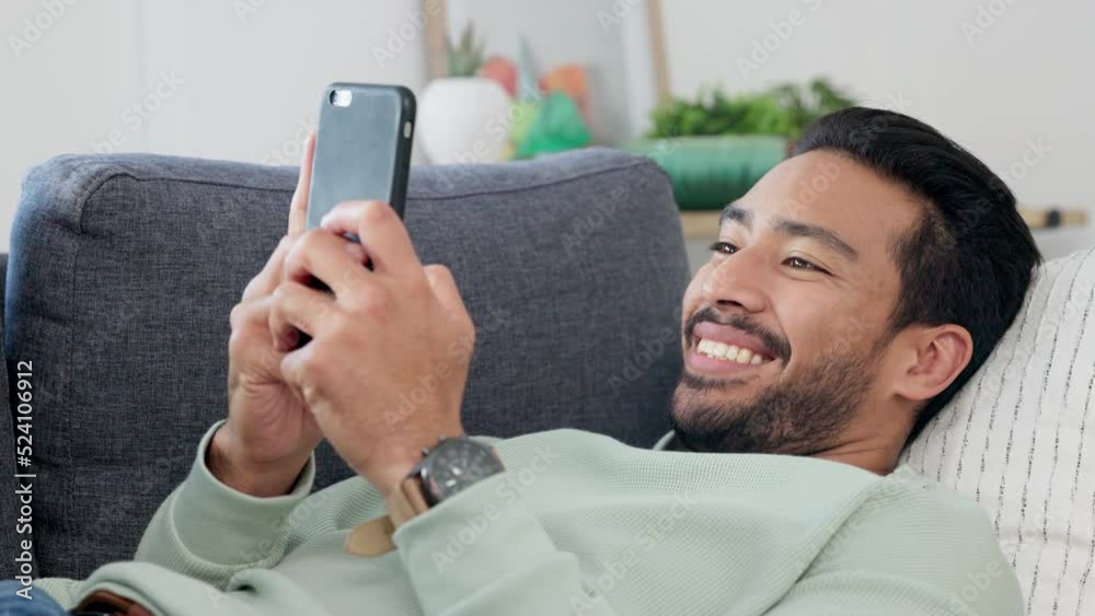Poster texting, happy and relaxing man typing on phone while browsing the internet, playing a game or chatt