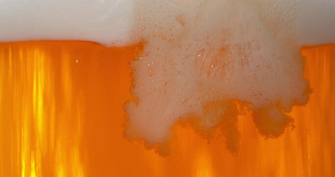 Super slow motion of macro shot of pouring beer drink, close-up. Filmed on high speed cinema camera, 1000 fps.
