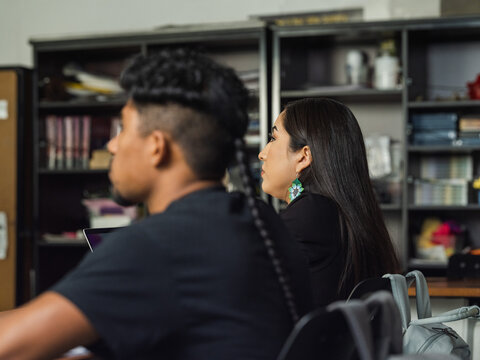 Native girl with beaded earrings in class