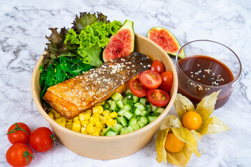 KOREAN BAKED SALMON with salad, tomato and sauce served in a bowl isolated on grey background side view healthy korean food