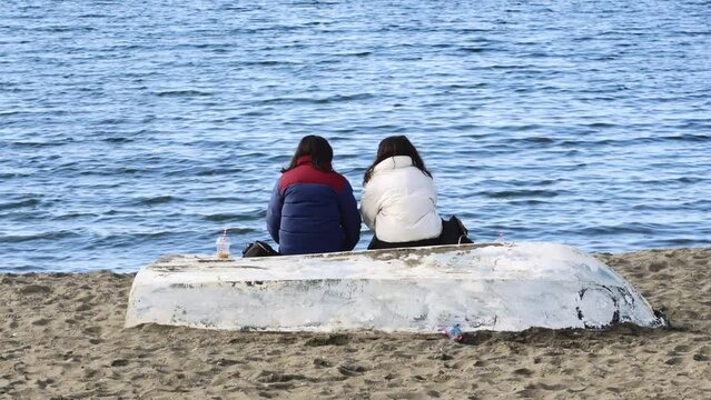 Couple friends on the beach talking in puerto varas chile