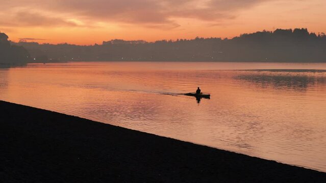 Man in Kayak at sunset in puerto varas chile