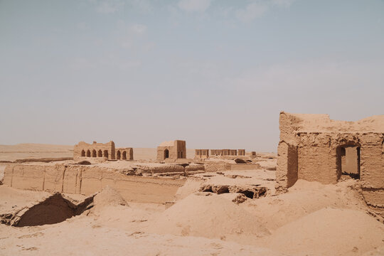 Old caravanserai in desert on sunny day
