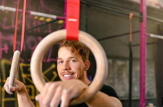 Male athlete preparing to exercise with gymnastic rings