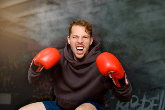 Male boxer taking break in gym