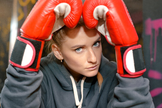 Female boxer taking break in gym